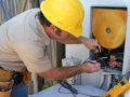 An air conditioning tech working on a heat recovery unit.