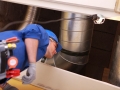 Plumber standing under a heating duct