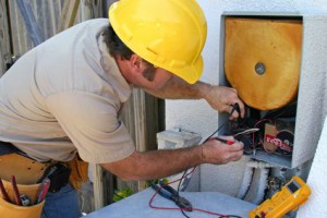 An air conditioning tech working on a heat recovery unit.